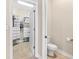 Functional bathroom featuring a toilet and an open doorway revealing a walk-in closet at 20053 Heritage Point Dr, Tampa, FL 33647