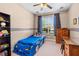 Fun ' bedroom featuring a car-shaped bed, playful decor, and a bright, cheerful ambiance at 20053 Heritage Point Dr, Tampa, FL 33647