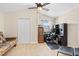 Bedroom with a desk setup, closet, and ceiling fan, providing a functional workspace at 20053 Heritage Point Dr, Tampa, FL 33647