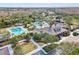 Aerial of community center featuring a pool, clubhouse, playground, and well-maintained landscaping at 20053 Heritage Point Dr, Tampa, FL 33647