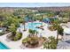 Aerial view of a resort-style community pool with lounging areas and tropical landscaping at 20053 Heritage Point Dr, Tampa, FL 33647