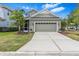 Beautiful home exterior featuring a two-car garage, well-manicured lawn, and inviting curb appeal at 20053 Heritage Point Dr, Tampa, FL 33647
