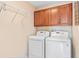 Practical laundry room with a washer, dryer, overhead storage, and ample space at 20053 Heritage Point Dr, Tampa, FL 33647