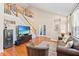 Spacious living room featuring hardwood floors, vaulted ceilings, and staircase access to the upper level at 20053 Heritage Point Dr, Tampa, FL 33647