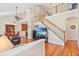 Open-concept living room with hardwood floors, vaulted ceilings, and a staircase leading to the second floor at 20053 Heritage Point Dr, Tampa, FL 33647