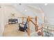 Upstairs loft area featuring a piano, a reading nook, and views of the home's lower level at 20053 Heritage Point Dr, Tampa, FL 33647