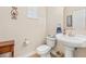 Cozy powder room with a pedestal sink, decorative mirror, and neutral color palette at 20053 Heritage Point Dr, Tampa, FL 33647