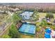 Overhead view of tennis and pickleball courts surrounded by trees in a residential community at 20053 Heritage Point Dr, Tampa, FL 33647
