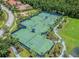 Aerial view of community tennis courts surrounded by lush landscaping and trees at 20053 Heritage Point Dr, Tampa, FL 33647