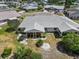 Beautiful aerial view showcasing the home's new roof, screened lanai, and landscaped backyard in quiet neighborhood at 204 Cactusflower Ln, Sun City Center, FL 33573