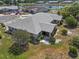 An aerial view highlights the home's screened patio, landscaping, and peaceful neighborhood near a scenic pond at 204 Cactusflower Ln, Sun City Center, FL 33573