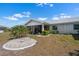 View of a backyard showing a white house and manicured landscaping at 204 Cactusflower Ln, Sun City Center, FL 33573
