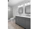 Modern bathroom with a double vanity, granite countertop, and glass door shower at 204 Cactusflower Ln, Sun City Center, FL 33573