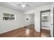 Bright bedroom featuring hardwood floors, mirrored closet doors, and natural light at 204 Cactusflower Ln, Sun City Center, FL 33573