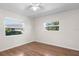 Bedroom featuring hardwood floors and lots of natural light from two windows at 204 Cactusflower Ln, Sun City Center, FL 33573