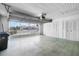 Spacious garage featuring a door, a large opening and storage cabinets at 204 Cactusflower Ln, Sun City Center, FL 33573