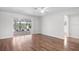 Bright and airy living room boasting hardwood floors and large windows providing lots of natural light at 204 Cactusflower Ln, Sun City Center, FL 33573