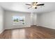 Spacious living room with hardwood floors, a ceiling fan, and a bright window at 204 Cactusflower Ln, Sun City Center, FL 33573