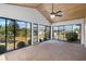 Enclosed sunroom with multiple glass doors overlooking the landscaped backyard at 204 Cactusflower Ln, Sun City Center, FL 33573