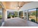 Bright sunroom featuring multiple glass doors and a wooden ceiling with fan at 204 Cactusflower Ln, Sun City Center, FL 33573