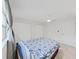 A well-lit bedroom has tile flooring, a ceiling fan, and double-door closets, offering ample storage at 2501 Harn Blvd # H39, Clearwater, FL 33764