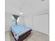 A cozy bedroom features neutral paint, tile floor, ceiling fan, and double-door closets at 2501 Harn Blvd # H39, Clearwater, FL 33764