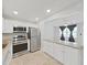 Bright kitchen features stainless steel appliances, granite countertops, and tiled floors at 2501 Harn Blvd # H39, Clearwater, FL 33764