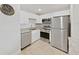 Bright kitchen features stainless steel appliances, granite countertops, and tiled floors at 2501 Harn Blvd # H39, Clearwater, FL 33764