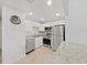 Bright kitchen features stainless steel appliances, granite countertops, and tiled floors at 2501 Harn Blvd # H39, Clearwater, FL 33764