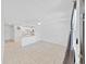 Bright living room with neutral tile floors, ceiling fan, and an open view to the kitchen at 2501 Harn Blvd # H39, Clearwater, FL 33764