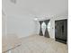 Bright living room with tile flooring, ceiling fan, natural light from the window, and black door at 2501 Harn Blvd # H39, Clearwater, FL 33764