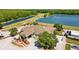 Scenic aerial view of Lexington Oaks Golf Club, set amongst lush greenery and a glistening lake at 25304 Lexington Oaks Blvd, Wesley Chapel, FL 33544