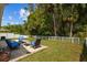 Expansive backyard with a well-maintained lawn, white picket fence, and comfortable seating area, perfect for relaxation at 25304 Lexington Oaks Blvd, Wesley Chapel, FL 33544