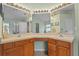Bright bathroom features a double sink vanity, countertop space, and decorative mirrors at 25304 Lexington Oaks Blvd, Wesley Chapel, FL 33544