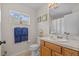 Bathroom with window, blue towels, and toilet at 25304 Lexington Oaks Blvd, Wesley Chapel, FL 33544