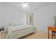 Well-lit bedroom features a ceiling fan, carpet flooring, and a window at 25304 Lexington Oaks Blvd, Wesley Chapel, FL 33544
