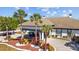 Lexington Oaks Golf Club entrance with palm trees, tidy landscaping, and convenient golf cart parking at 25304 Lexington Oaks Blvd, Wesley Chapel, FL 33544