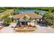 Stunning Lexington Oaks Golf Club with beautiful landscaping, a golf course, and a shimmering lake in the background at 25304 Lexington Oaks Blvd, Wesley Chapel, FL 33544