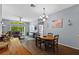 Open-concept dining area features wood-look tile floors and a chandelier at 25304 Lexington Oaks Blvd, Wesley Chapel, FL 33544