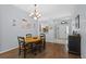 Dining room with wood floors, neutral walls, and traditional chandelier at 25304 Lexington Oaks Blvd, Wesley Chapel, FL 33544