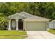 Charming single-story home with a well-maintained lawn and attached two-car garage at 25304 Lexington Oaks Blvd, Wesley Chapel, FL 33544