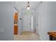 Bright foyer with tile flooring and a view into the kitchen and other living areas at 25304 Lexington Oaks Blvd, Wesley Chapel, FL 33544