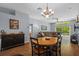 Open floor plan with wood flooring, chandelier, fan, and view to the Gathering room at 25304 Lexington Oaks Blvd, Wesley Chapel, FL 33544