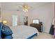 Main bedroom featuring a ceiling fan, dresser, and an entry to the en-suite at 25304 Lexington Oaks Blvd, Wesley Chapel, FL 33544