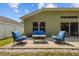 Outdoor patio featuring brick pavers, seating, and a view of the landscaped backyard, great for entertaining at 25304 Lexington Oaks Blvd, Wesley Chapel, FL 33544