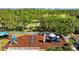 Community playground featuring slides, swings, and climbing structures surrounded by a white picket fence at 25304 Lexington Oaks Blvd, Wesley Chapel, FL 33544
