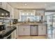 Modern kitchen with granite countertops, stainless steel appliances, and white cabinets at 2532 Fentress Pl, Holiday, FL 34691