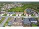Aerial view of a community with lush greenery, ponds and mature trees at 2611 Eagle Crest Ct, Holiday, FL 34691