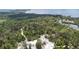 Overhead shot of wooded landscape featuring winding trails and a parking area at 2611 Eagle Crest Ct, Holiday, FL 34691