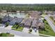 An aerial view of a house in a lovely neighborhood with manicured lawns and mature trees at 2611 Eagle Crest Ct, Holiday, FL 34691